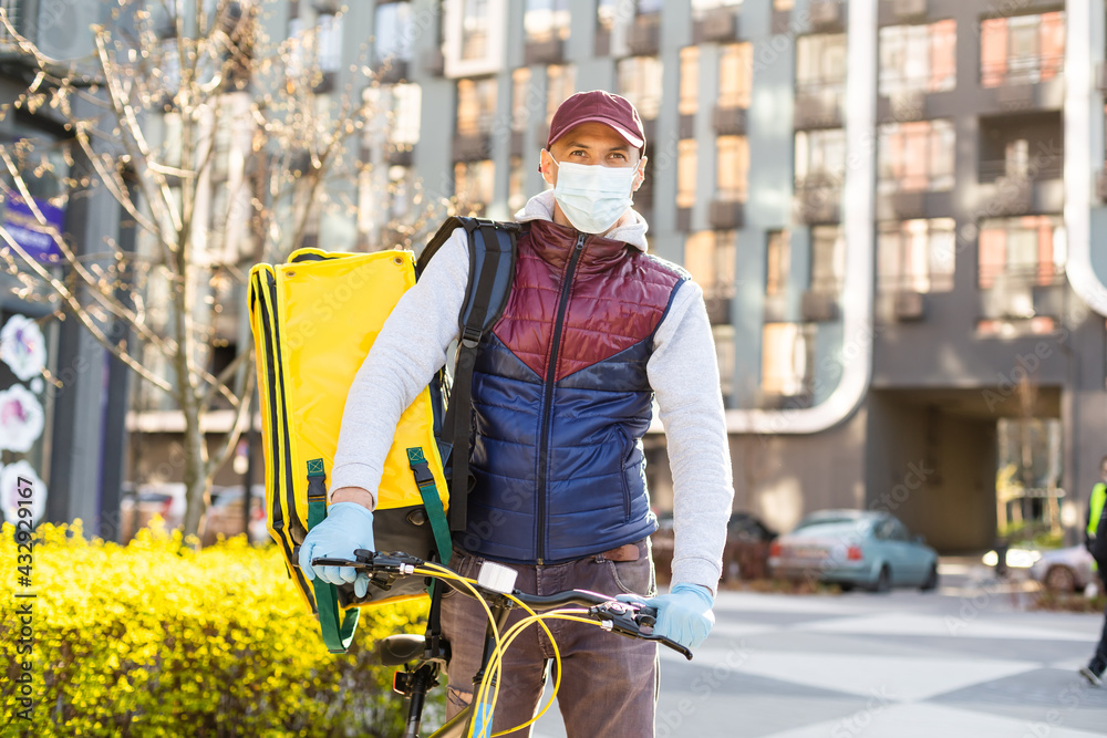 Obraz premium Young delivery man with yellow backpack takeaway concept