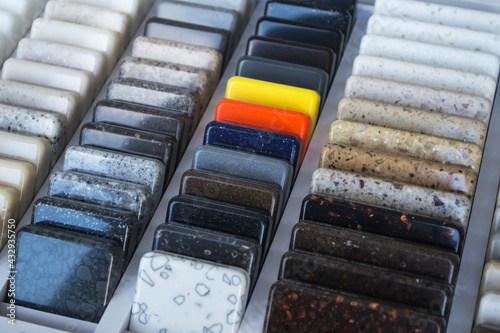 Layout: colorful specimens of granite, marble and quartz natural stone slabs.Close-up of stone kitchen countertops samples