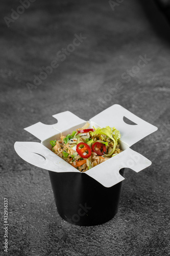 Rice in wok box for food delivery. Asian spicy dish for street restaurant and fast food cafe