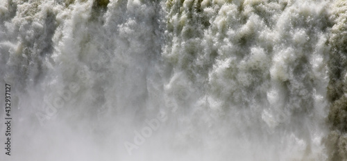 Waterfall background and texture.  Panorama closeup view of the famous Iguazu falls. The mist and falling white water.  © Gonzalo