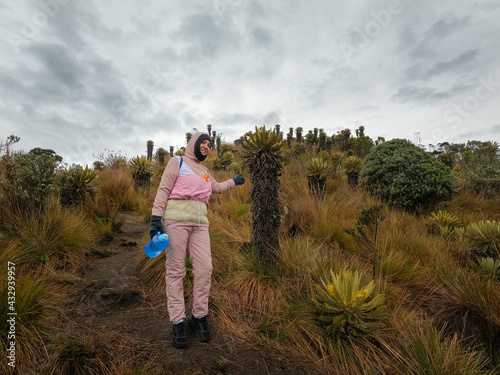 Mujer parada en un paramo junto a los frailejones photo