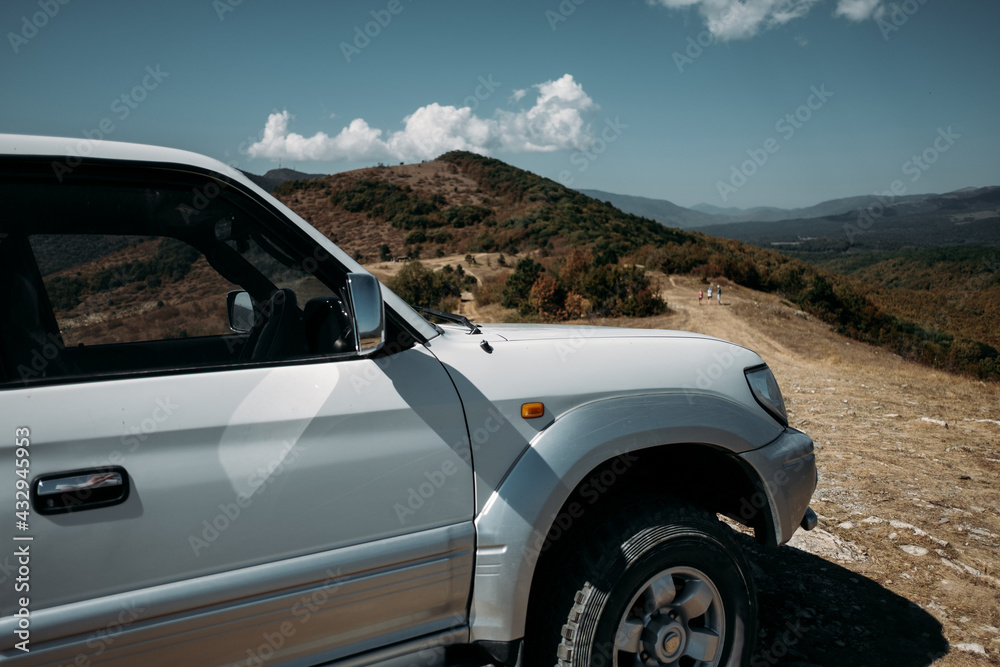 Close-up white off road car. Traveling by auto, adventure, expedition on a SUV.