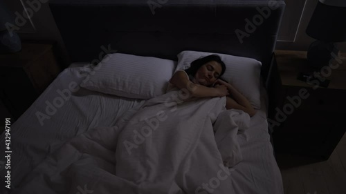 The girl has insomnia, she is spinning in bed, she cannot sleep. She picks up her smartphone, tries to go back to sleep, but to no effect.