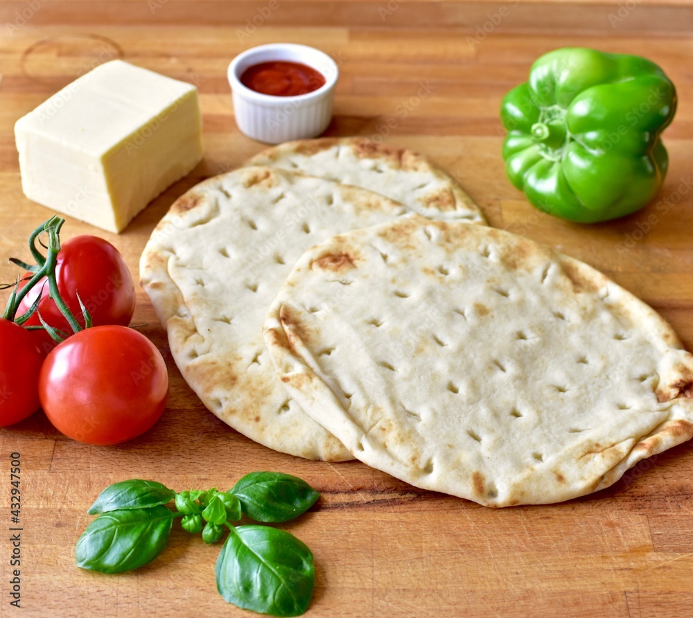 Homemade naan bread simple make at home flatbread meals, vegetable margarita pizzas. Photo concept, food lifestyle background, close-up, flat lay Homemade naan bread simple make at home flatbread meals, vegetable margarita pizzas. Photo concept, food lifestyle background, close-up, flat lay