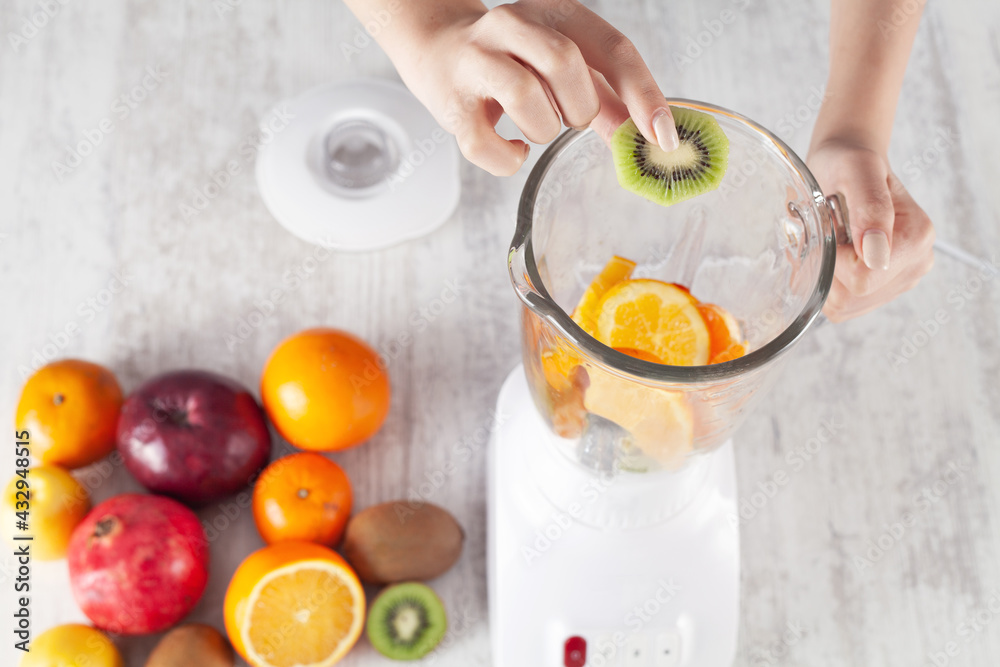 Girl mixing fruits with electric blender. Girl mixing fruits with electric blender.