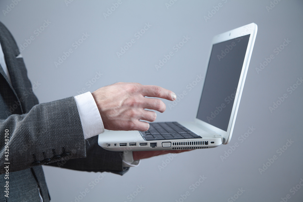 Businessman using laptop computer in office. Businessman using laptop computer in office.