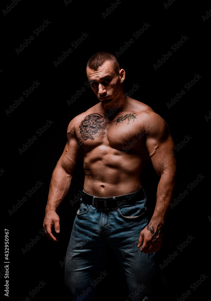 Handsome man with big muscles, posing at the camera Handsome man with big muscles, posing at the camera