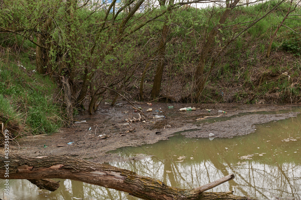 garbage and waste in the water by the river garbage and waste in the water by the river