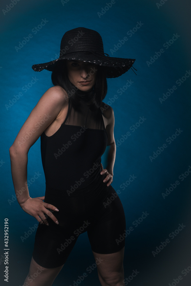 Elegant woman is posing with hat Elegant woman is posing with hat
