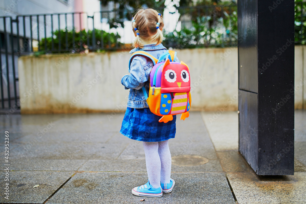 Adorable Toddler Girl With Funny Backpack Ready To Go To Daycare