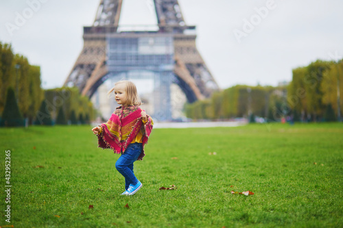 Adorable toddler girl near the Eiffel tower on a fall day in Paris, France © Ekaterina Pokrovsky
