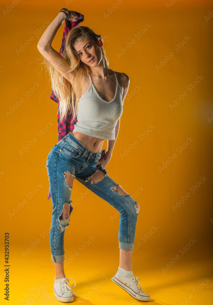 Young Woman In Yellow Tanktop And Eye Glasses Against Yellow Background Young Woman In Yellow Tanktop And Eye Glasses Against Yellow Background