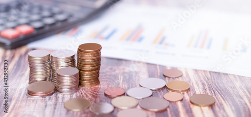 coin towers stand on a wooden table