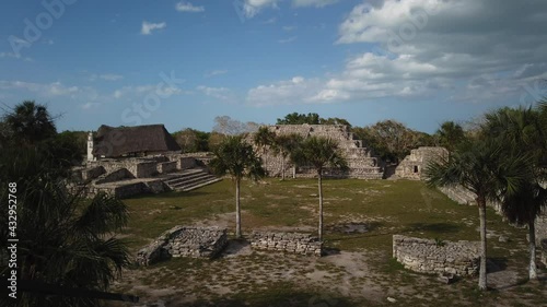 Time lapse wide angle of Catholic church with grass roof and Xcambo ruins in Telchac, Yucatan, Mexico. photo