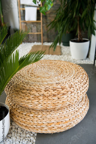 Wicker ottoman in the interior. Wicker furniture made of natural materials. texture of rattan with natural patterns