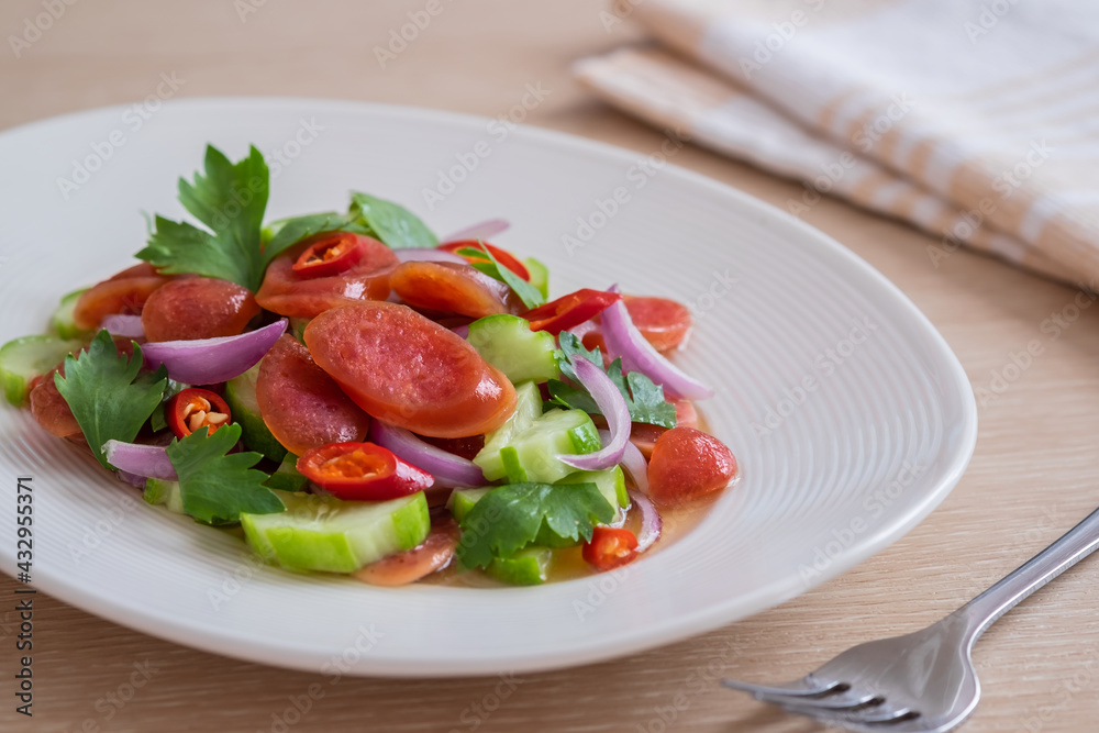 Spicy chinese pork sausage salad on plate, Thai food Spicy chinese pork sausage salad on plate, Thai food