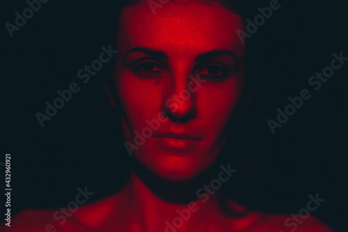 Portrait of a young woman in red light