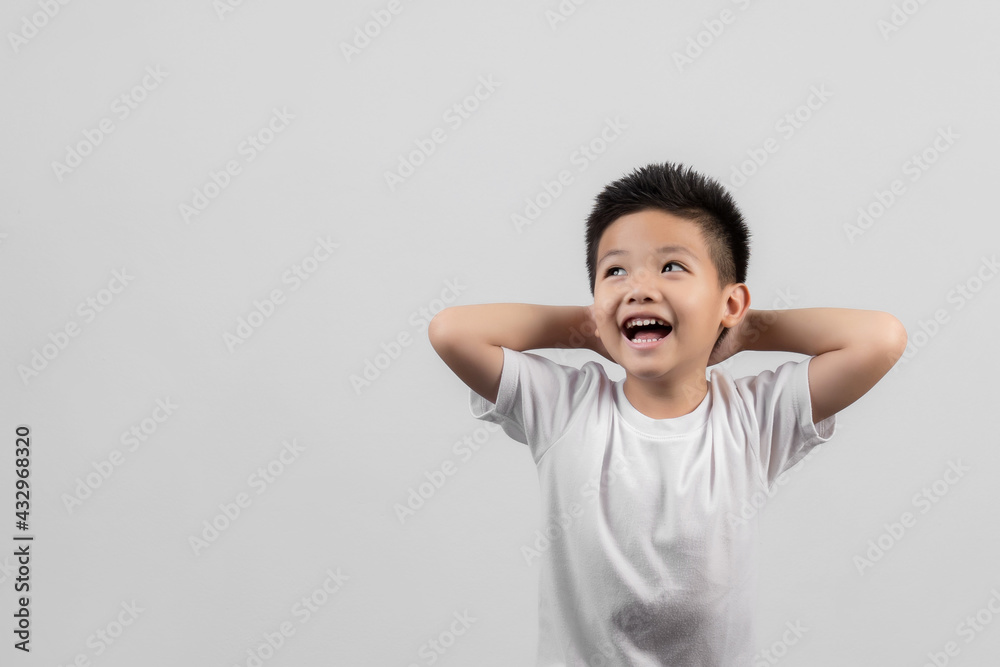 Smart little Asian boy studio portrait on gray background Smart little Asian boy studio portrait on gray background