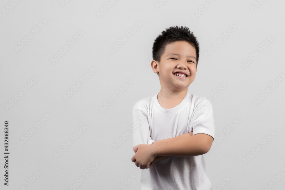 Smart little Asian boy studio portrait on gray background Smart little Asian boy studio portrait on gray background