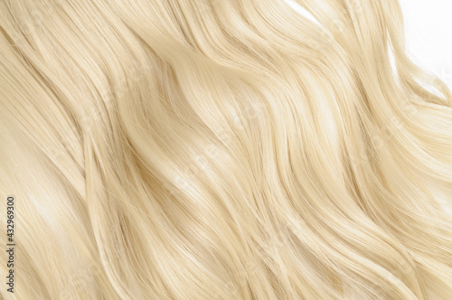 close up of single piece clip in wavy platinum blonde synthetic hair extensions