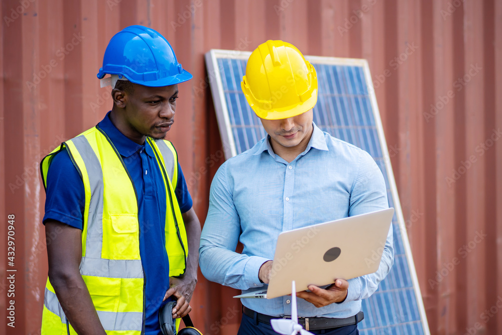 Two male energy engineers team discussing new project about to invest in install solar cells outside building or industrial factory Two male energy engineers team discussing new project about to invest in install solar cells outside building or industrial factory