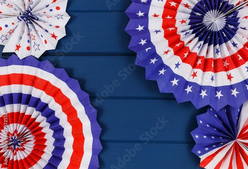 Decorations for 4th of July day of American independence, flag, candles, straws, paper fans. USA holiday decorations on a blue background, top view, flat lay 