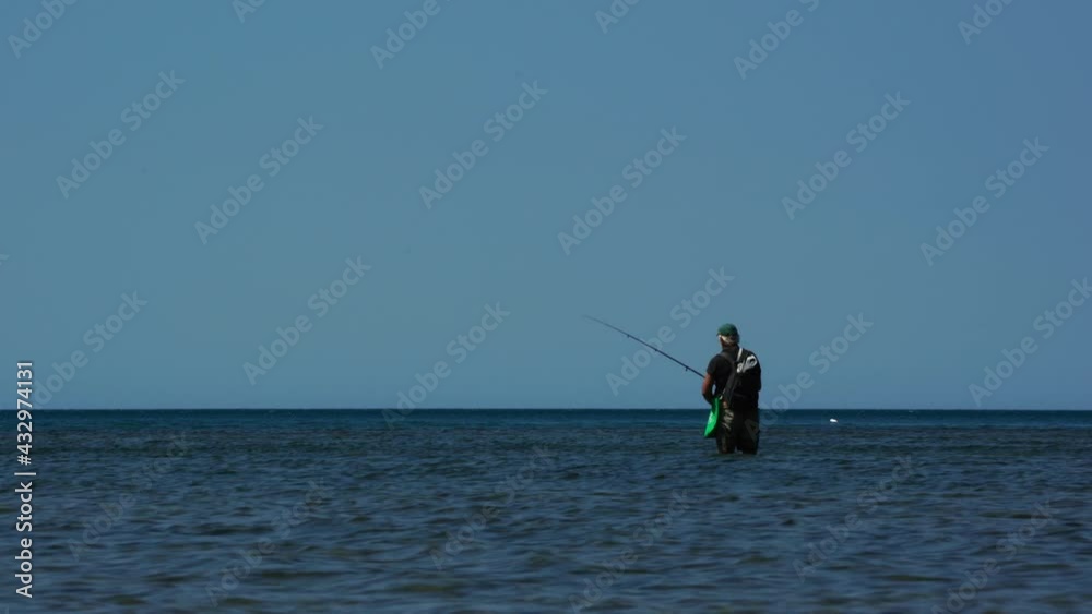 Fisherman fishing on the shallow sea water of the Mediterranean coastline Fisherman fishing on the shallow sea water of the Mediterranean coastline
