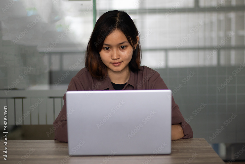 Attractive happy young girl student studying at the college library having video chat. Attractive happy young girl student studying at the college library having video chat.