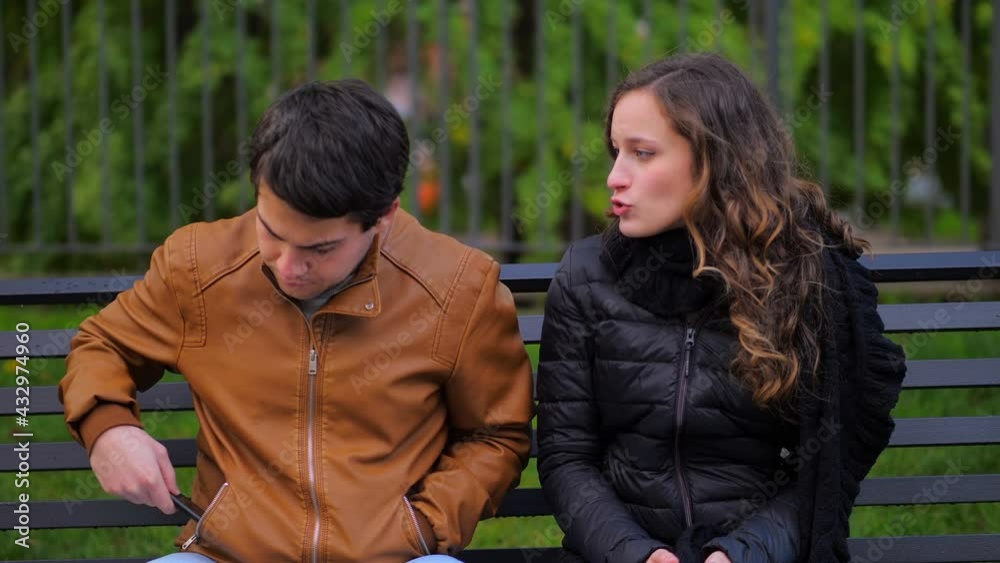 phone addiction - girl talks to her boyfriend who looks at cellphone phone addiction - girl talks to her boyfriend who looks at cellphone