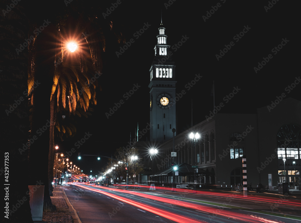 Clock tower with light trails at night