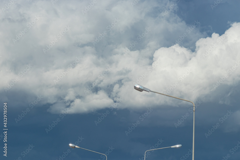 Rain clouds in the sky and street light poles