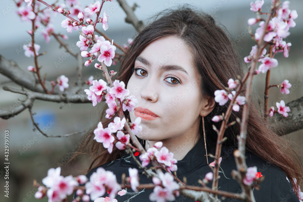 portrait of a girl in a blooming peach garden portrait of a girl in a blooming peach garden