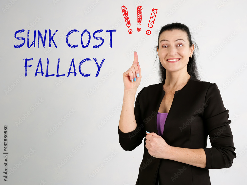 SUNK COST FALLACY exclamation marks phrase on the gray wall SUNK COST FALLACY exclamation marks phrase on the gray wall