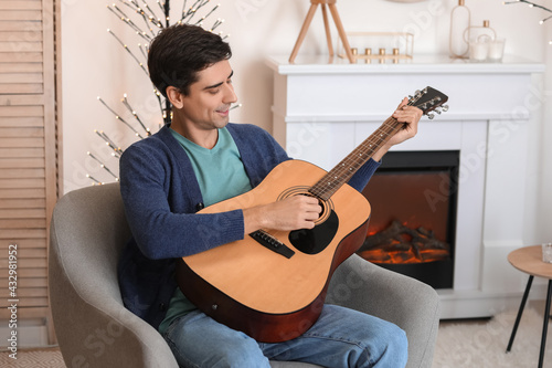 Smiling young man playing a...