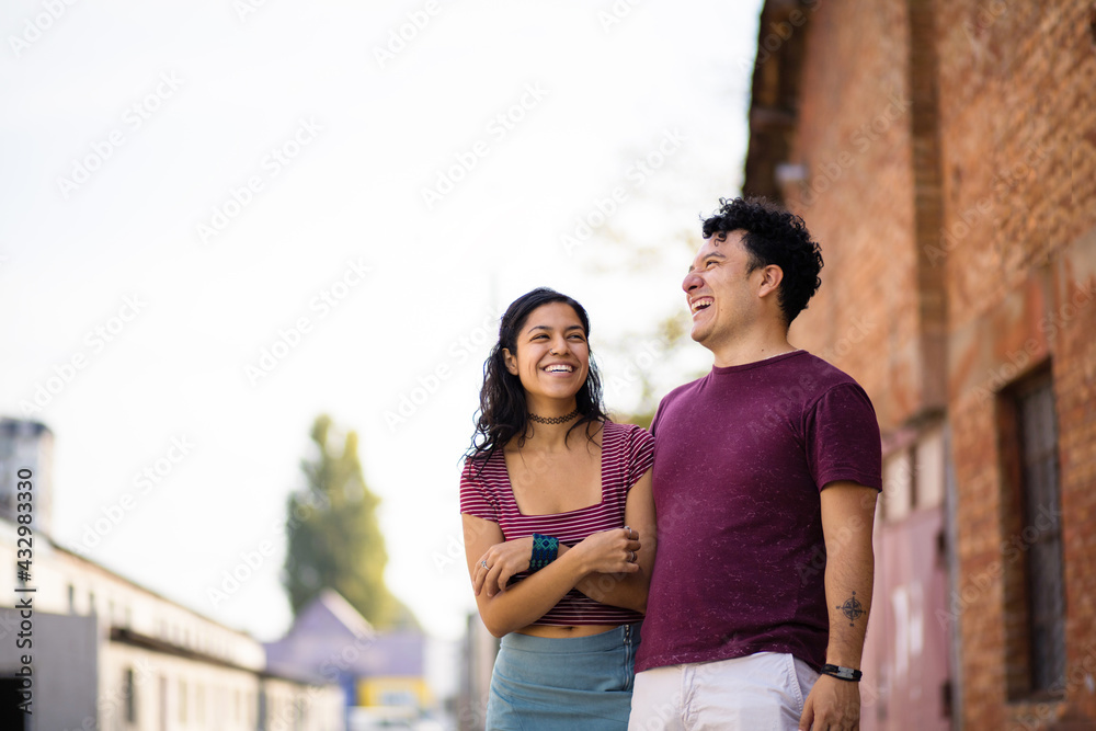 Young happy couple spending time on the street.