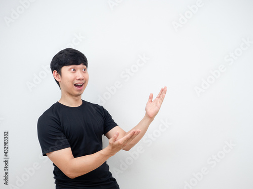 Asian man cheerful pointing hand at side present product concept copy space