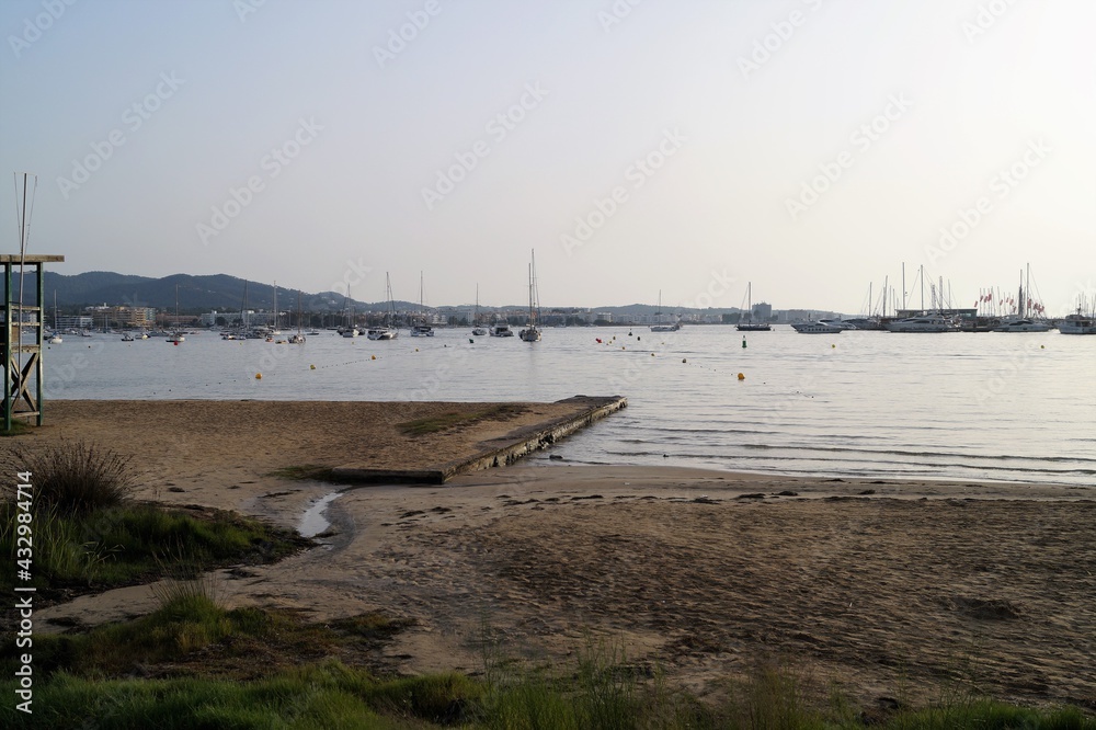 a beach on the island of Ibiza with boats at dusk on a summer night. Balearic Islands, Spain


