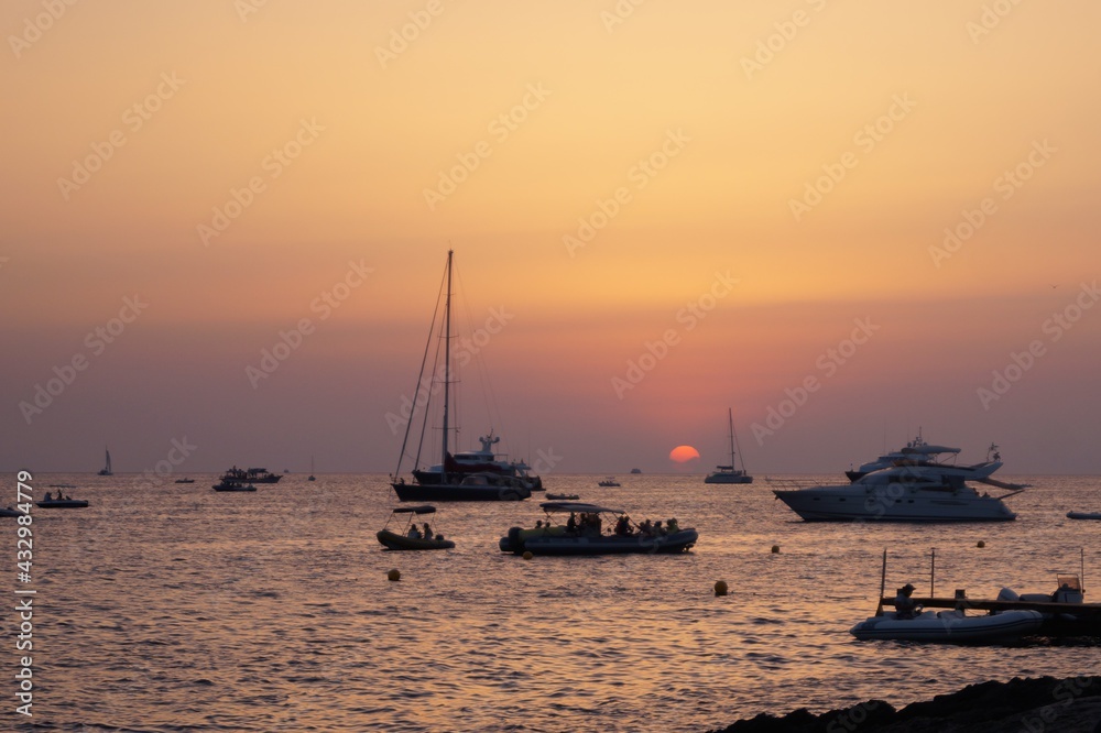 a beach on the island of Ibiza with boats at dusk on a summer night. Balearic Islands, Spain


