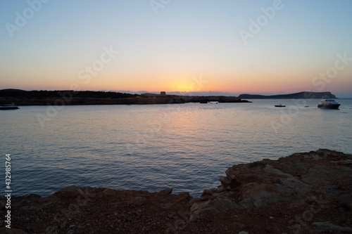 a beach on the island of Ibiza with boats at dusk on a summer night. Balearic Islands, Spain


