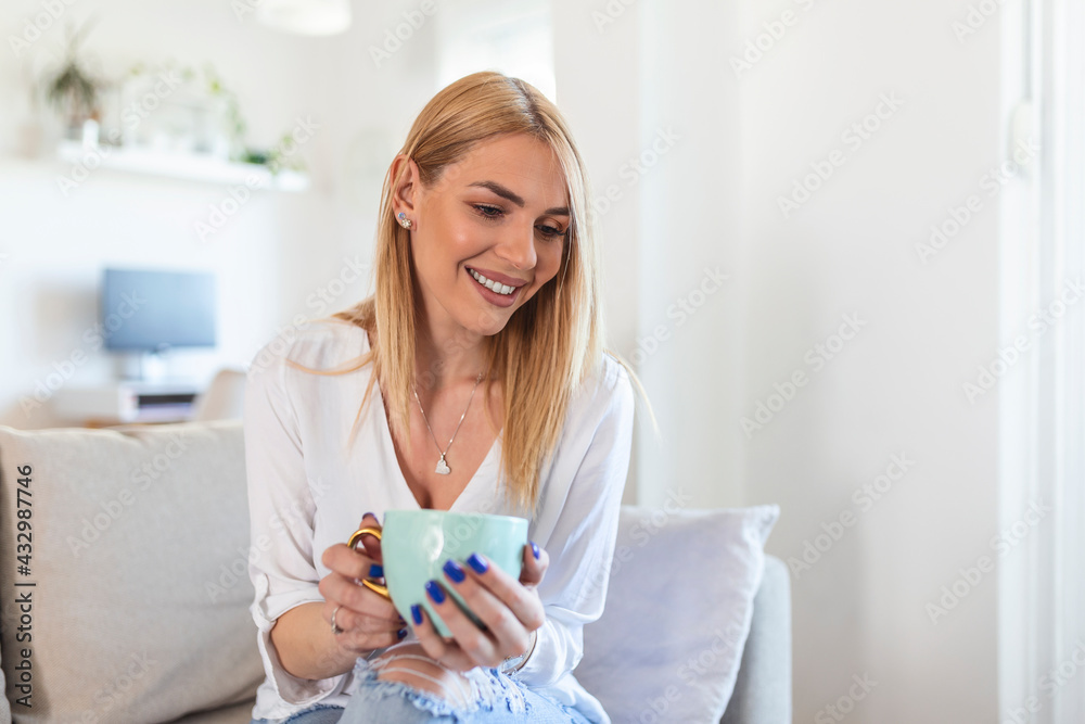 Closeup view of young woman with cup of hot drink at home, blank space. People, drinks and leisure concept - happy young woman with cup of tea or coffee at home