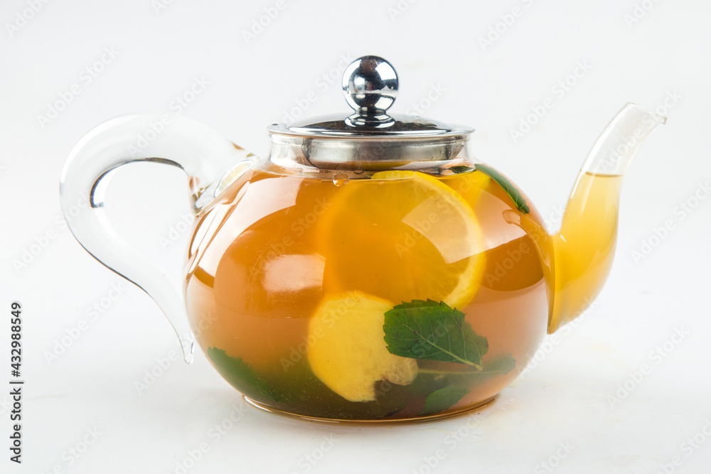 Isolated teapot of citrus tea with orange on the white background Isolated teapot of citrus tea with orange on the white background