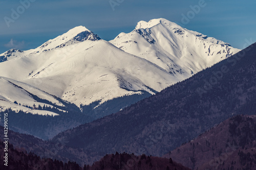 snow covered mountains in winter
two snowy mountain peaks of romania