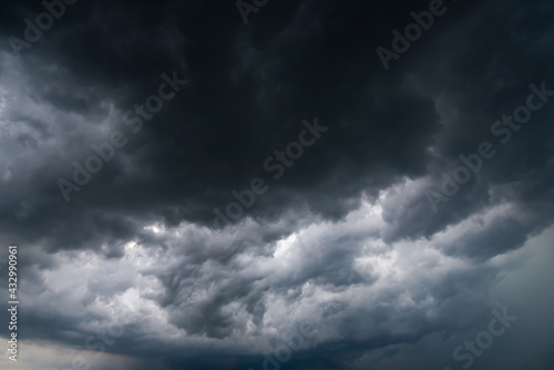 dark storm clouds with background,Dark clouds before a thunder-storm. © pinglabel