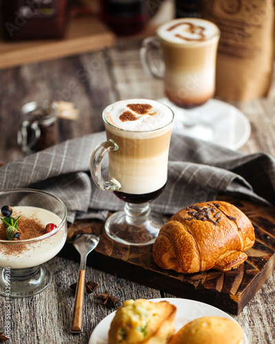 Served coffee cafe table with desserts and latte drinks