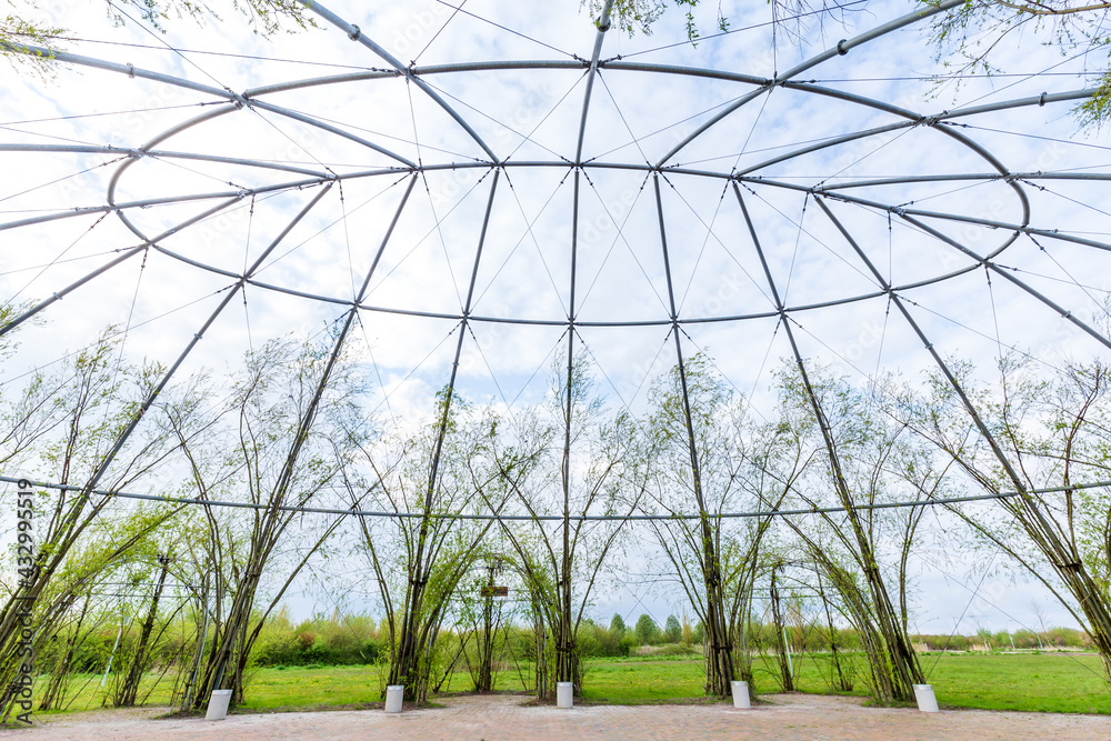 Fototapeta premium Natural green dome in park along Oldambt lake surrounding newly developed city Blauwestad in Oldambt Groningen in The Netherlands with natural green dome.