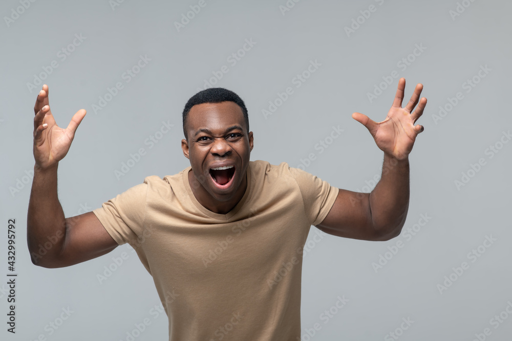 Emotional dark skinned man in cheerful mood Emotional dark skinned man in cheerful mood