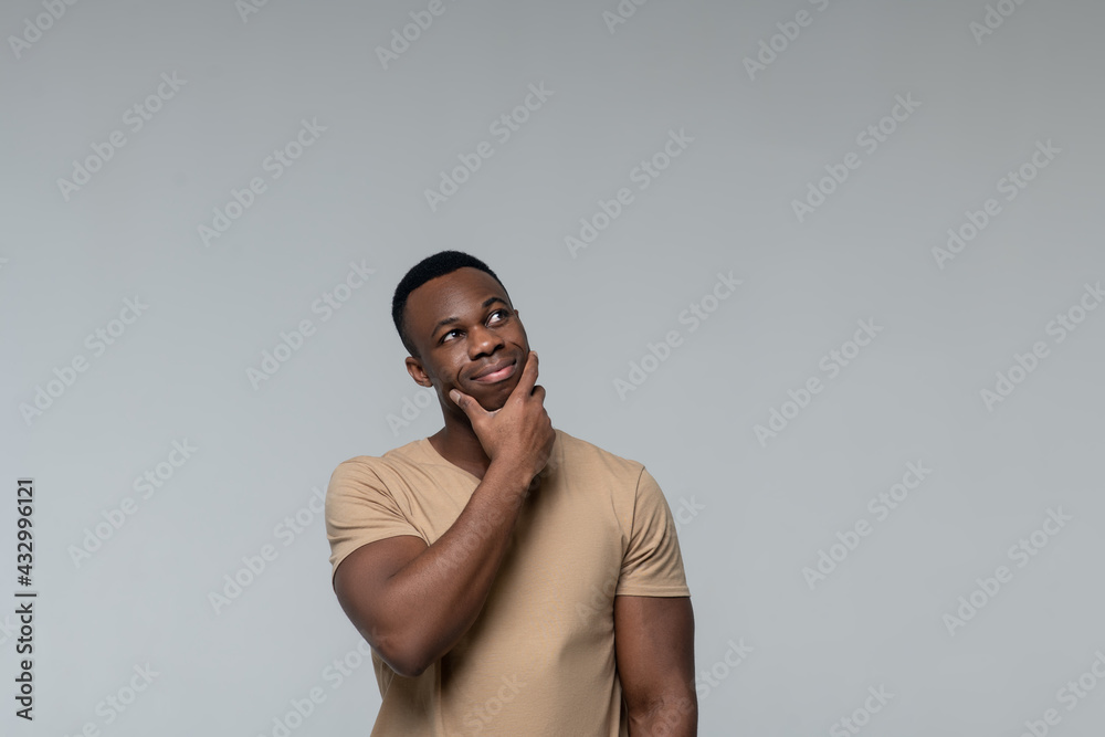 Pensive smiling man looking to side Pensive smiling man looking to side