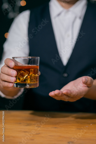 Barman pouring whiskey whiskey glass beautiful night there is a beautiful bokeh on background