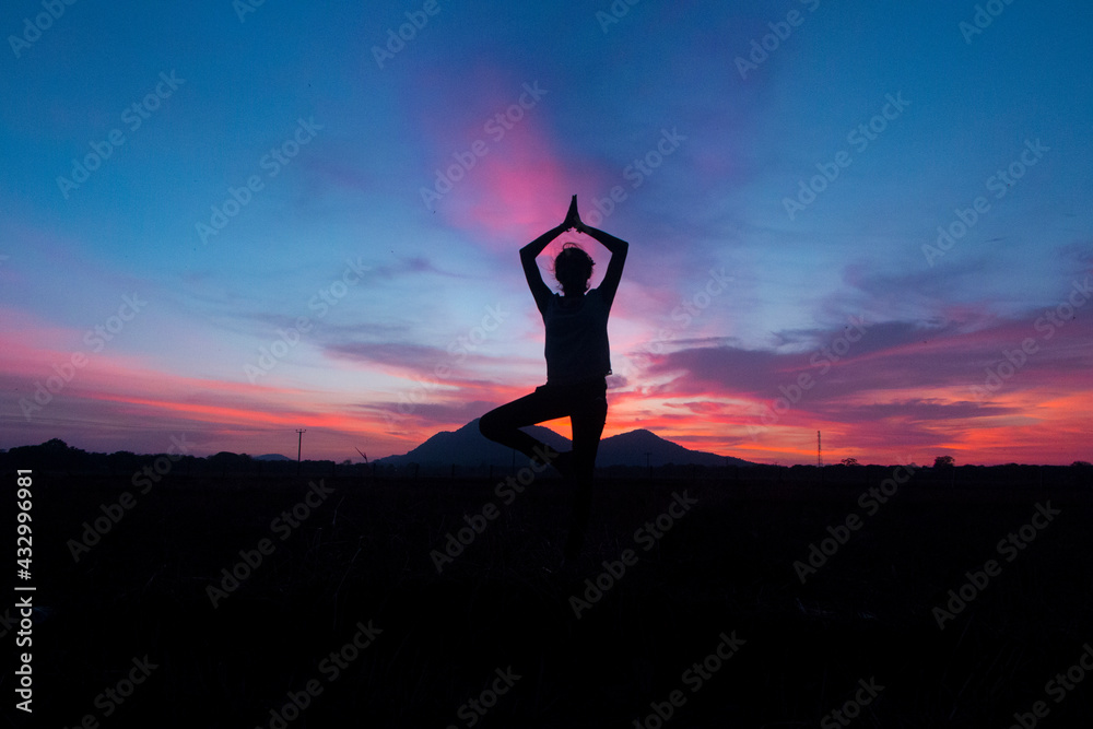 performing yoga at  beautiful environment  , sunset
