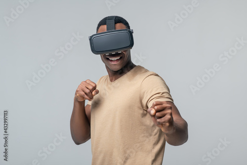 Man in virtual glasses and hands in fists